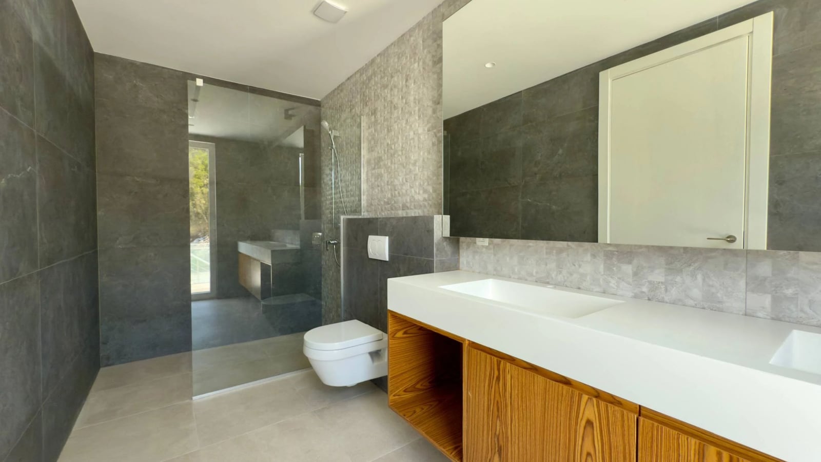 Modern bathroom in a villa in Krašići, Montenegro: shower cabin, stylish vanity, and porcelain tile finish.