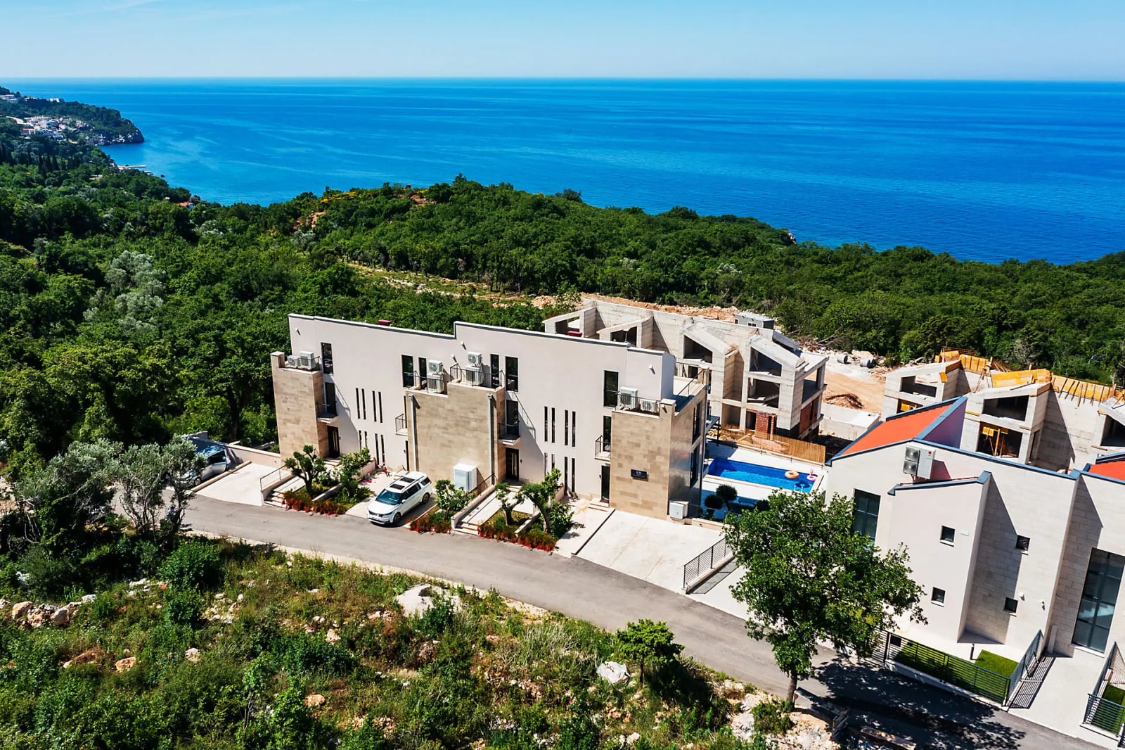 Modern villa with a pool and sea view in Reževići, Montenegro: aerial view of the property and surrounding grounds.