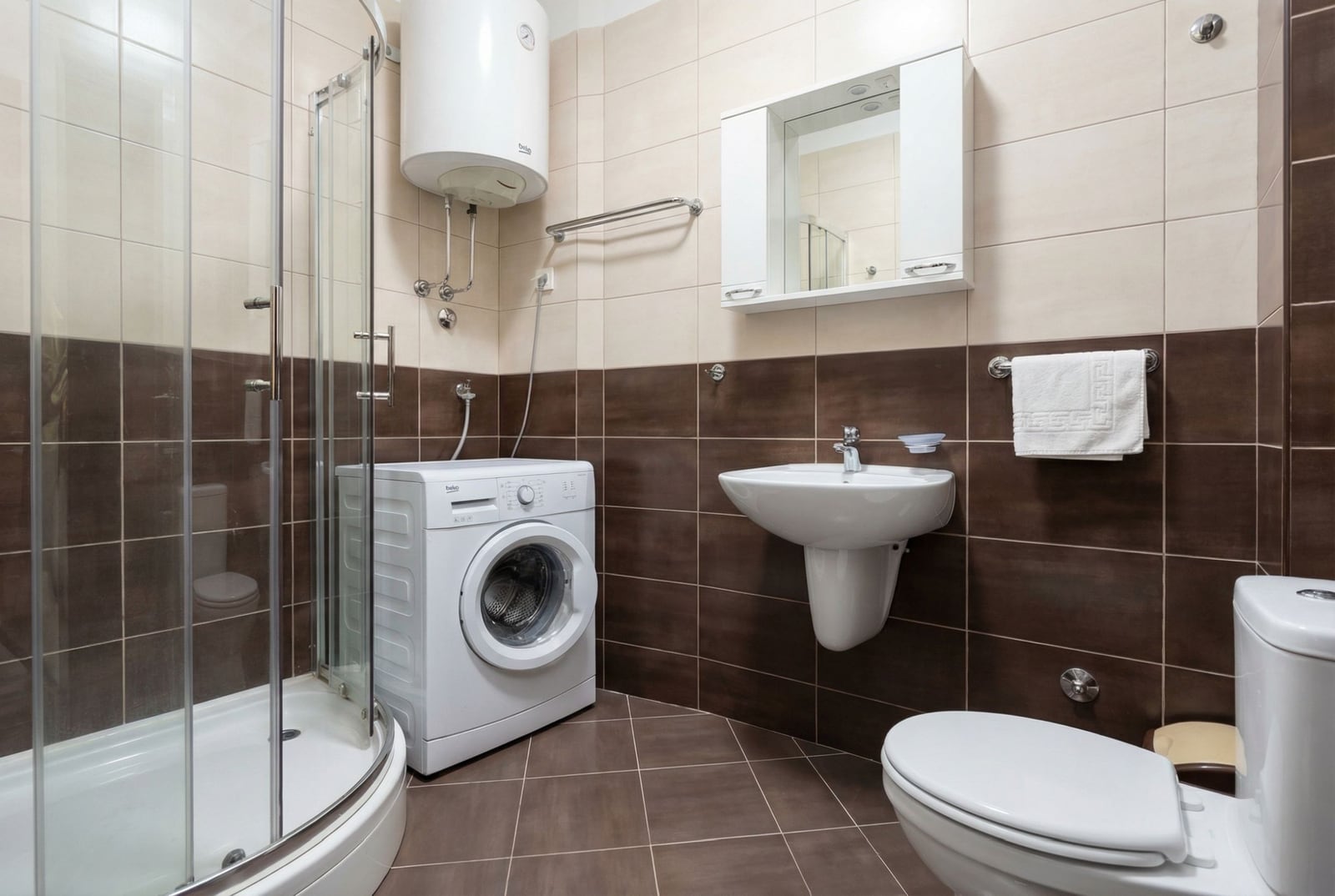 Modern bathroom with a shower cabin and washing machine in an apartment, Budva, Montenegro.
