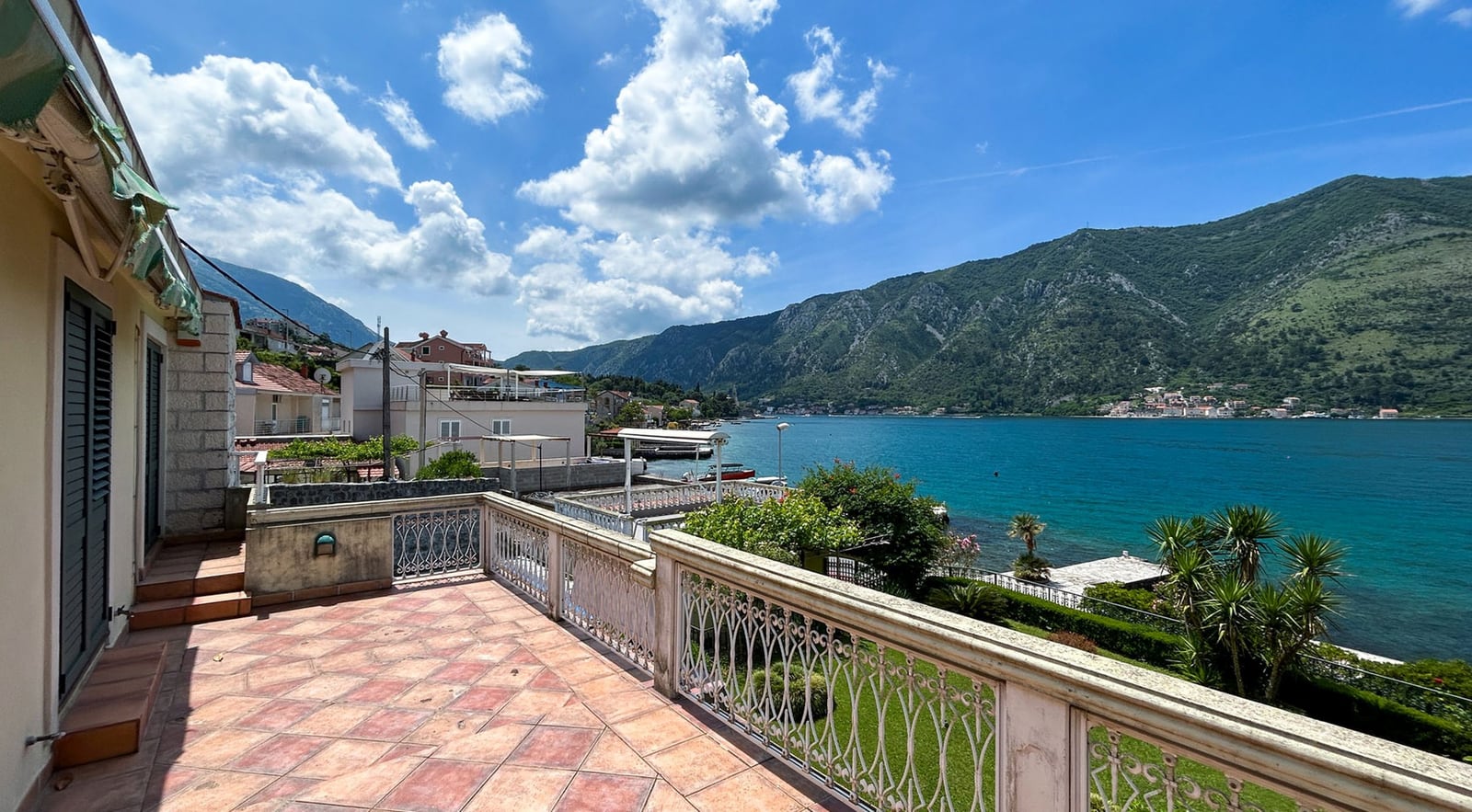 Spacious villa terrace in Dobrota, Montenegro, with panoramic views of Kotor Bay and the mountains.
