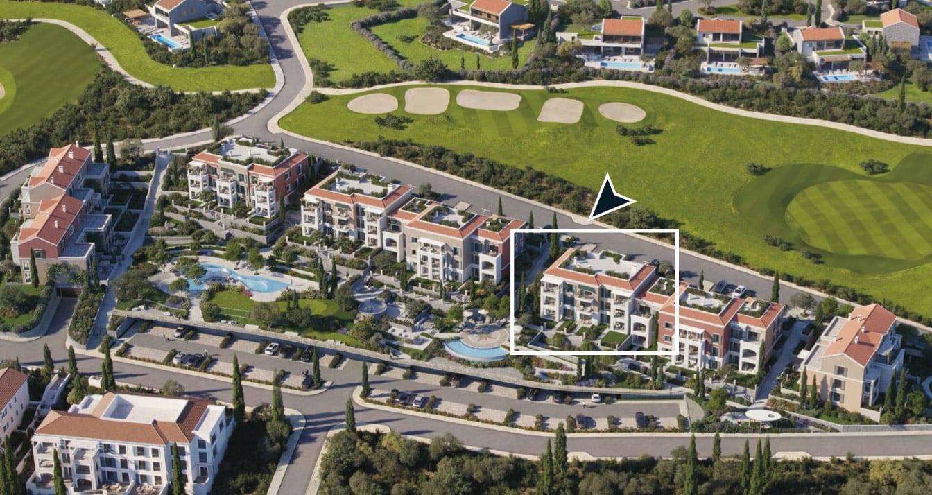 Aerial view of a residential complex in Luštica, Montenegro: modern apartments next to a golf course and pool.