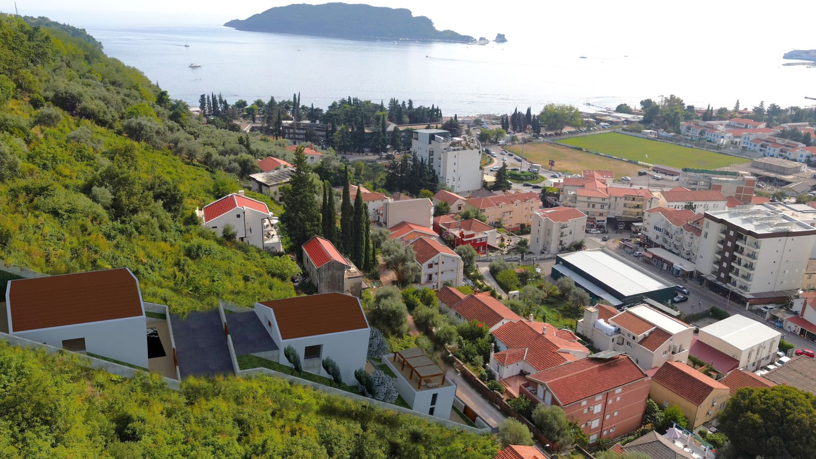 Aerial view of a land plot in Budva, Montenegro, with a panoramic view of the sea, St. Nicholas Island, and the city.