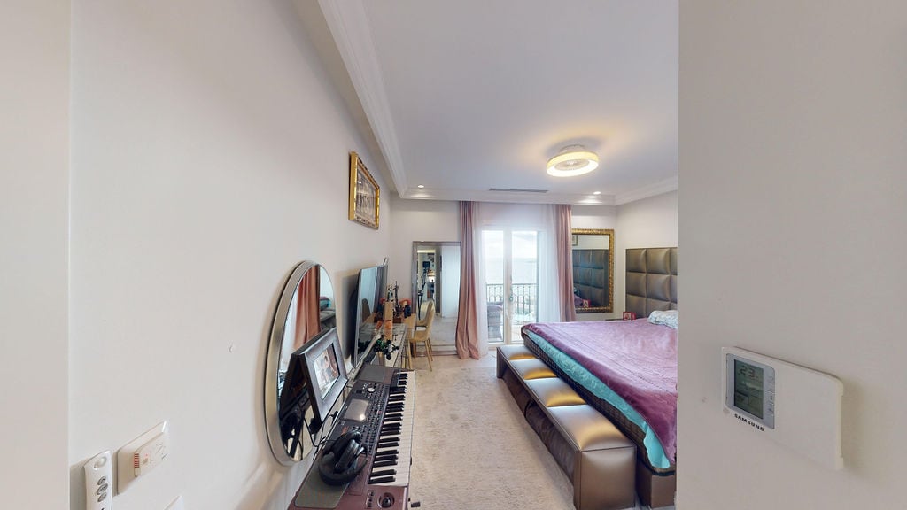 Bright bedroom in a townhouse, Luštica, Montenegro: double bed, synthesizer, and balcony access with a view.