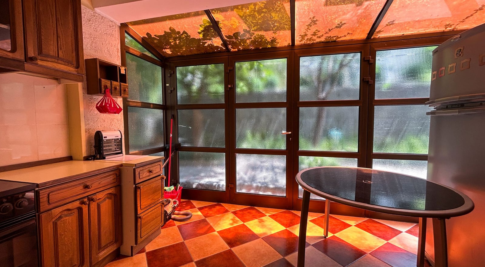 Kitchen with wooden cabinetry and panoramic glazing in a villa in Dobrota, Montenegro.