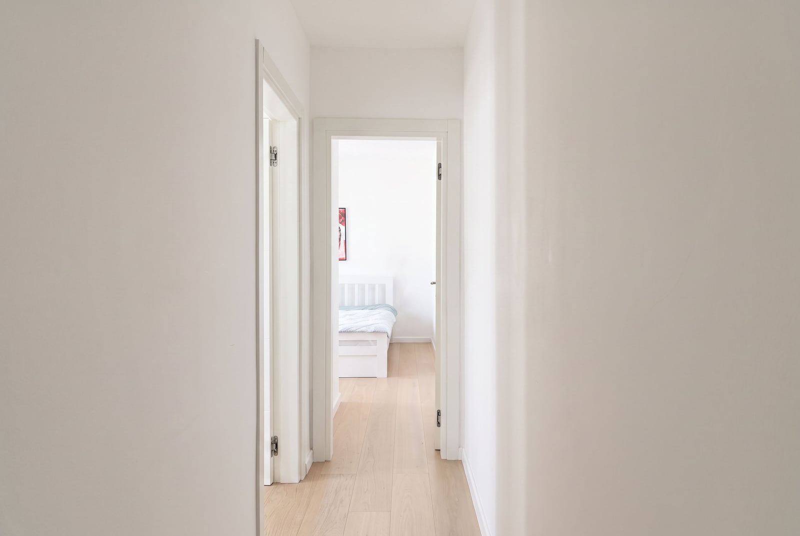 Bright hallway with white walls and wooden floor in an apartment in Tivat, Montenegro