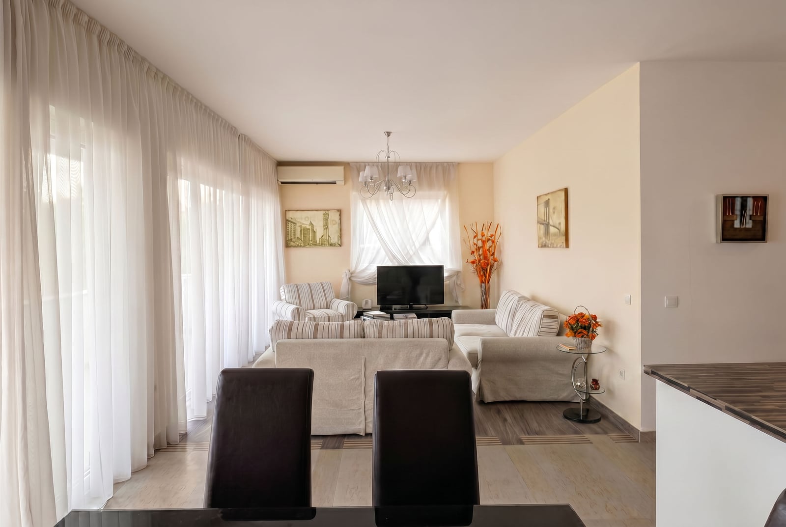 Bright living room with upholstered furniture in an apartment for sale in Kumbor, Montenegro: panoramic windows and modern interior.