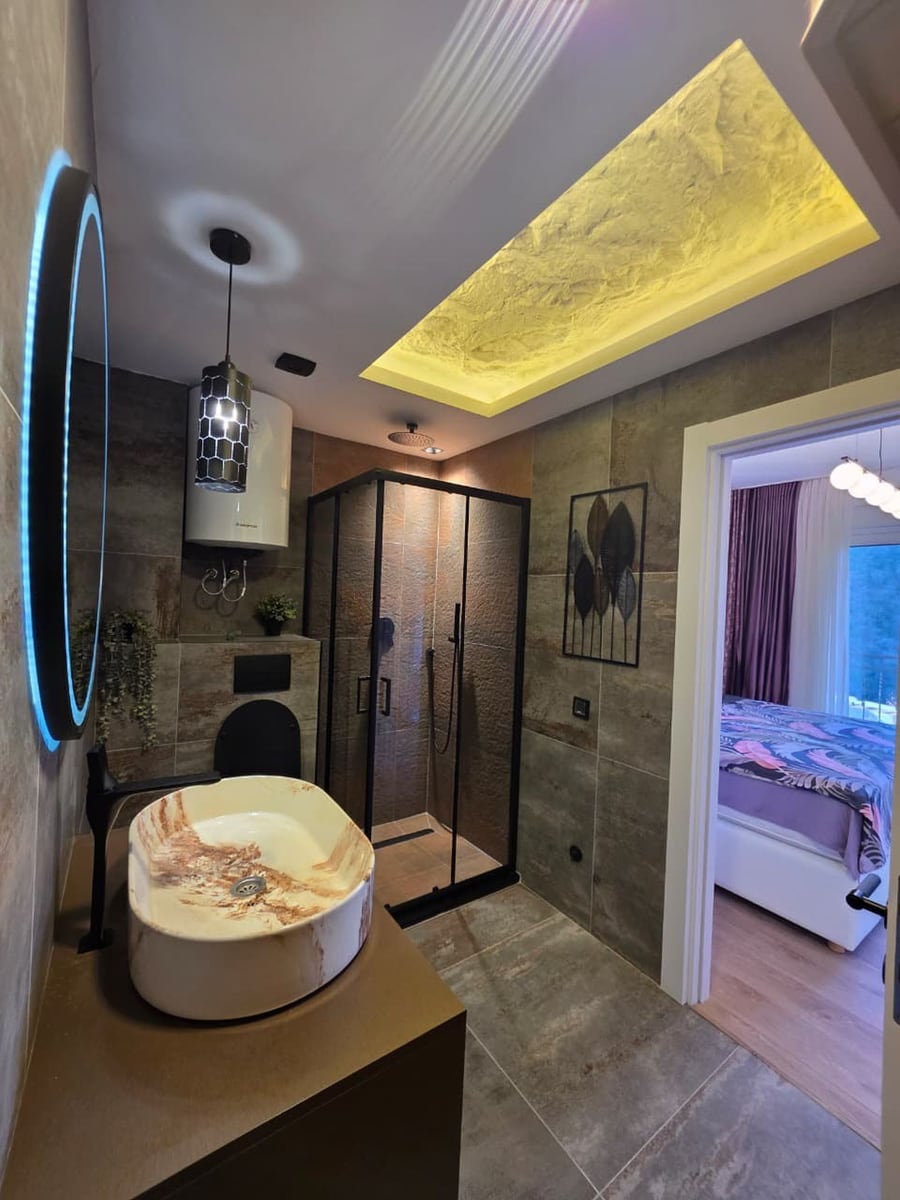 Modern bathroom with a shower cabin and designer sink in an apartment, Bečići, Montenegro.