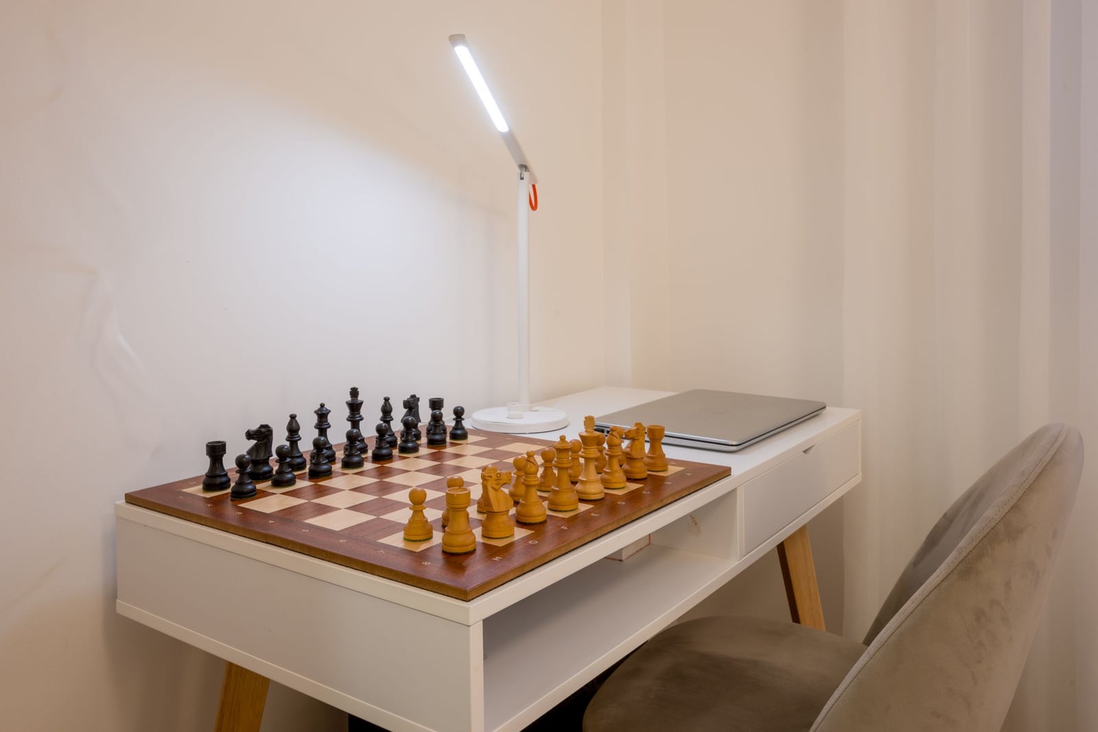 Workspace with a chessboard and a laptop in a modern apartment in Tivat, Montenegro.
