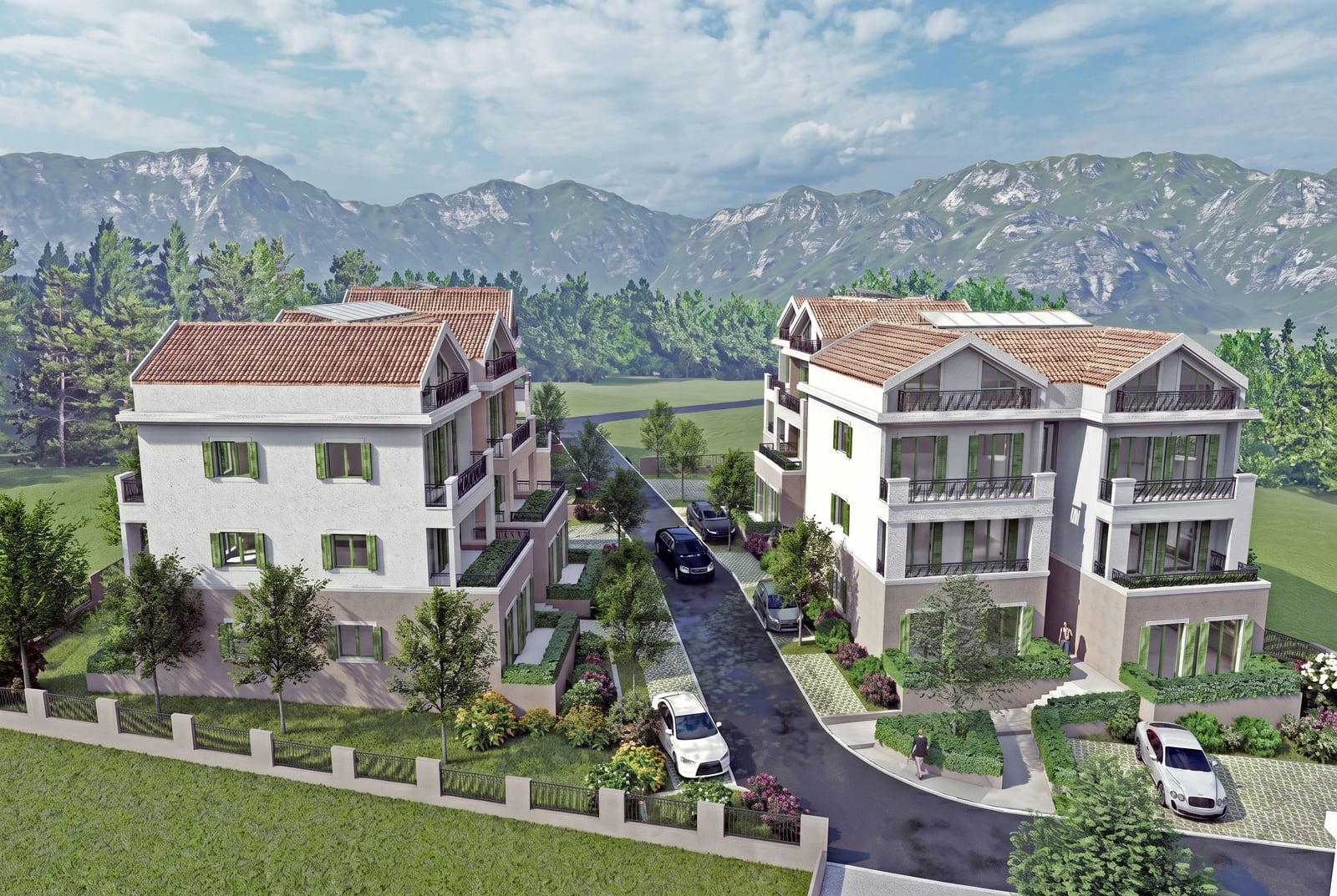 View of modern residential buildings in Tivat, Montenegro: three-story buildings with tiled roofs and mountain views.