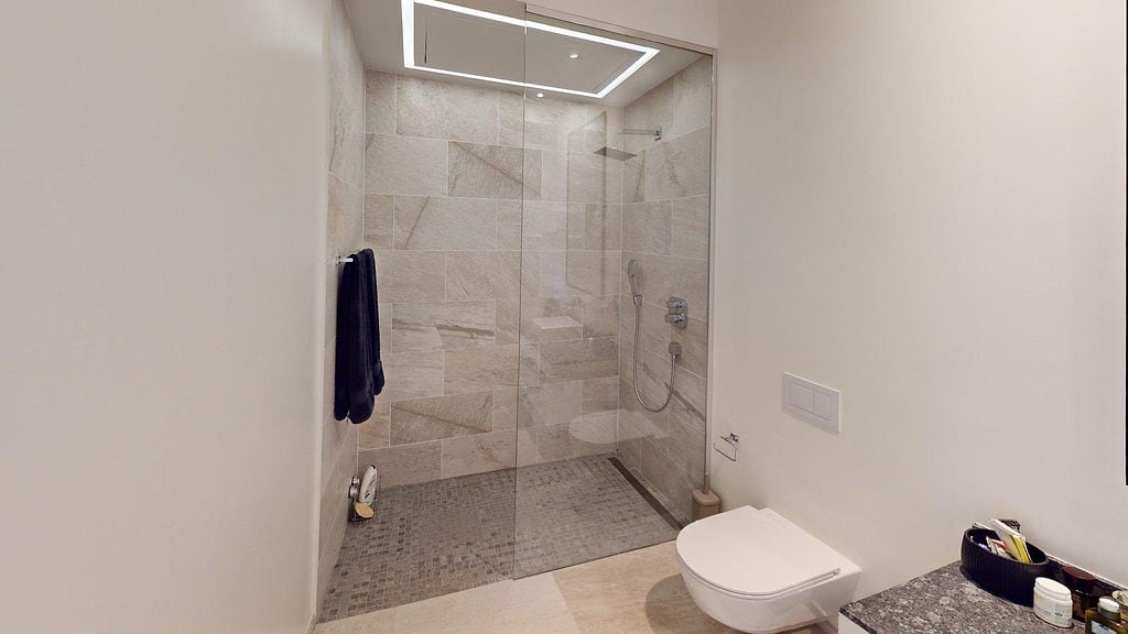 Modern bathroom with a shower cabin and stone finish in a luxury apartment, Luštica, Montenegro.