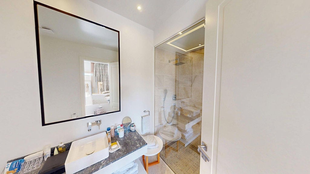 Modern bathroom with a shower cabin and stone countertop in an apartment, Luštica, Montenegro.
