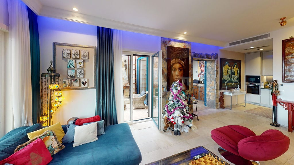 Living room in a Luštica Bay townhouse, Montenegro: modern furniture, designer decor, terrace access, and kitchen.