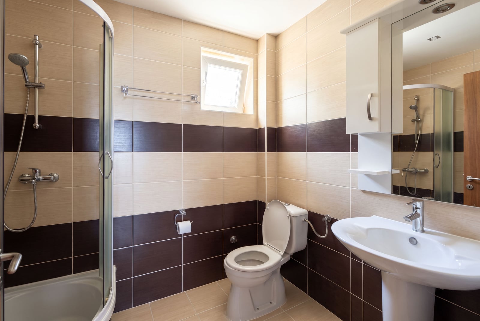 Modern bathroom with a shower cabin, sink, and toilet in an apartment in Tivat, Montenegro