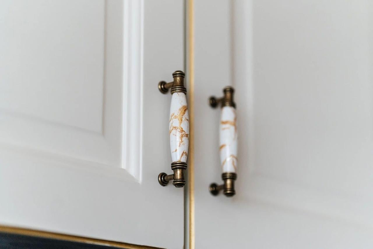 Details of the kitchen set with marble handles in an apartment in Budva, Montenegro. High-quality interior finishes.