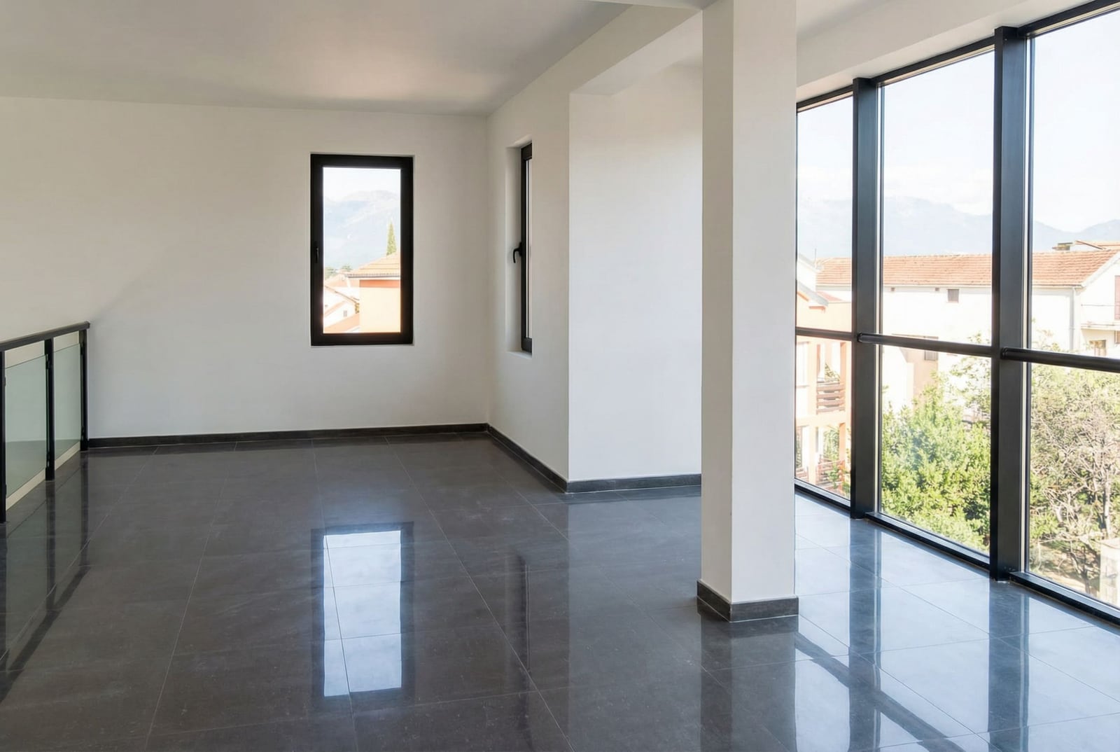 Bright living room with panoramic windows and dark tiled floor in Baošići, Herceg Novi, Montenegro.
