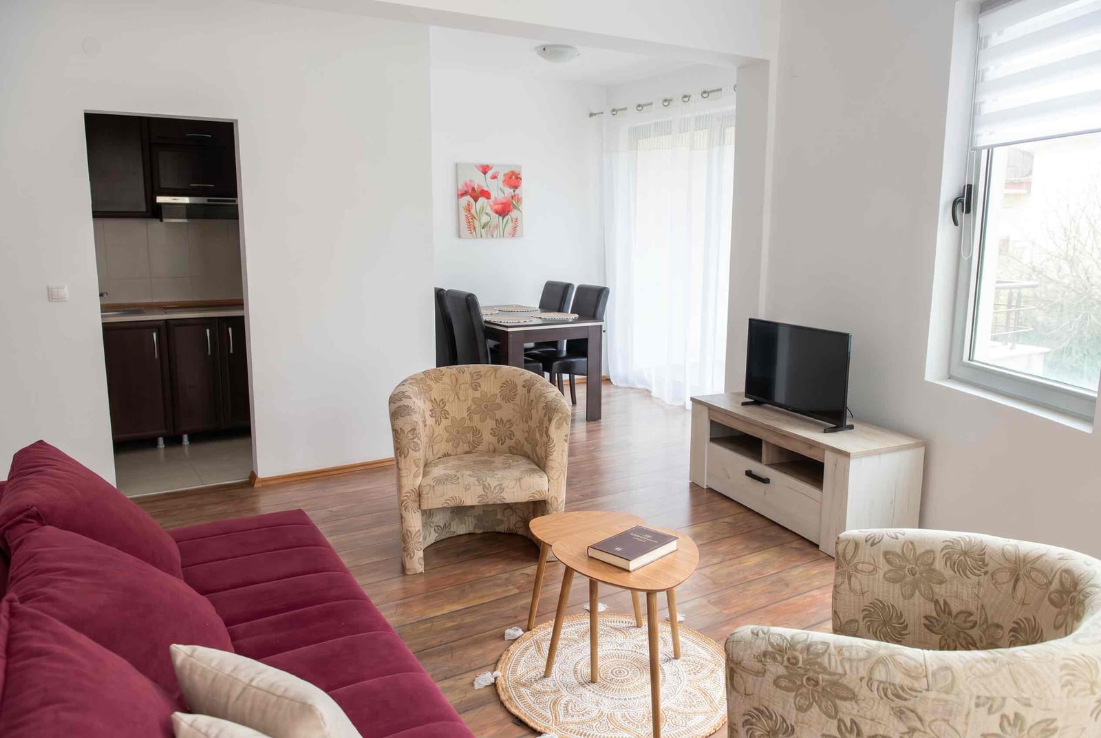 Living room with upholstered furniture and a dining area in an apartment in Bečići, Montenegro: modern interior with a kitchen.