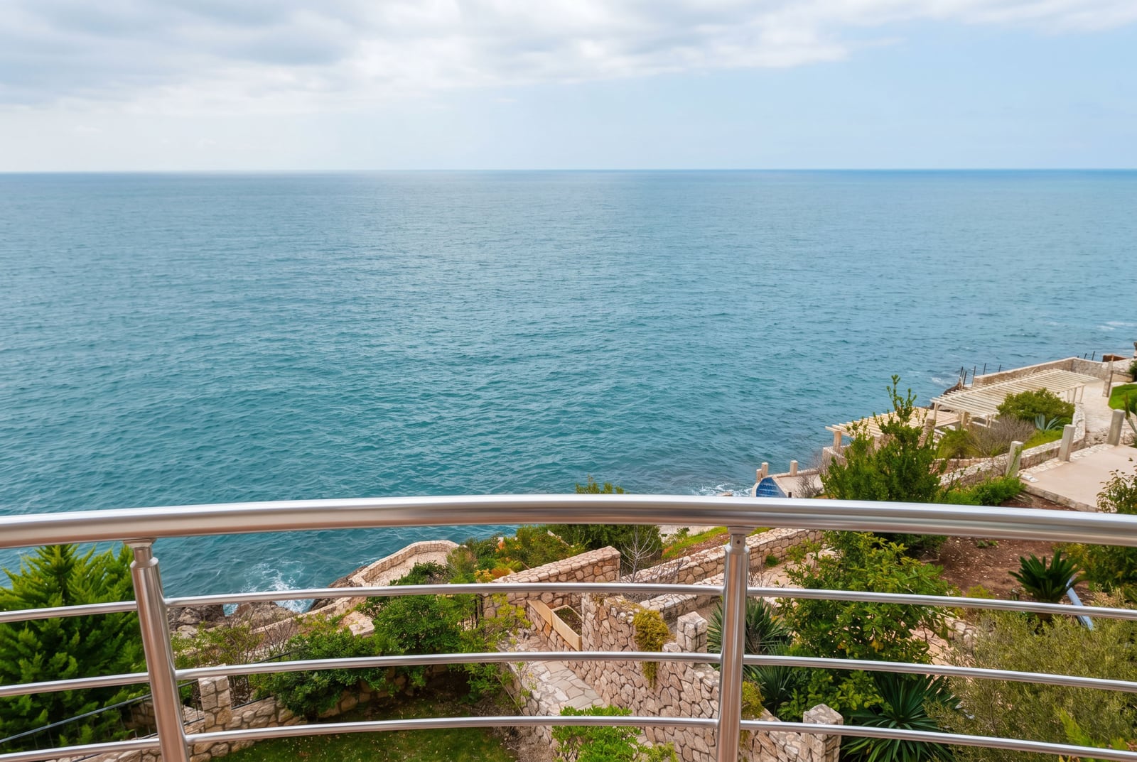View from the apartment balcony in Bar, Montenegro: panoramic view of the Adriatic Sea and the landscaped grounds.