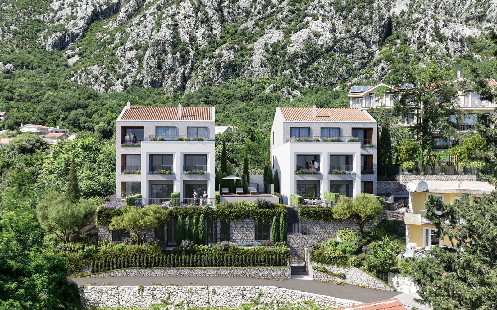 Modern white villas with panoramic windows and tiled roofs against a mountain backdrop in Orahovac, Montenegro.