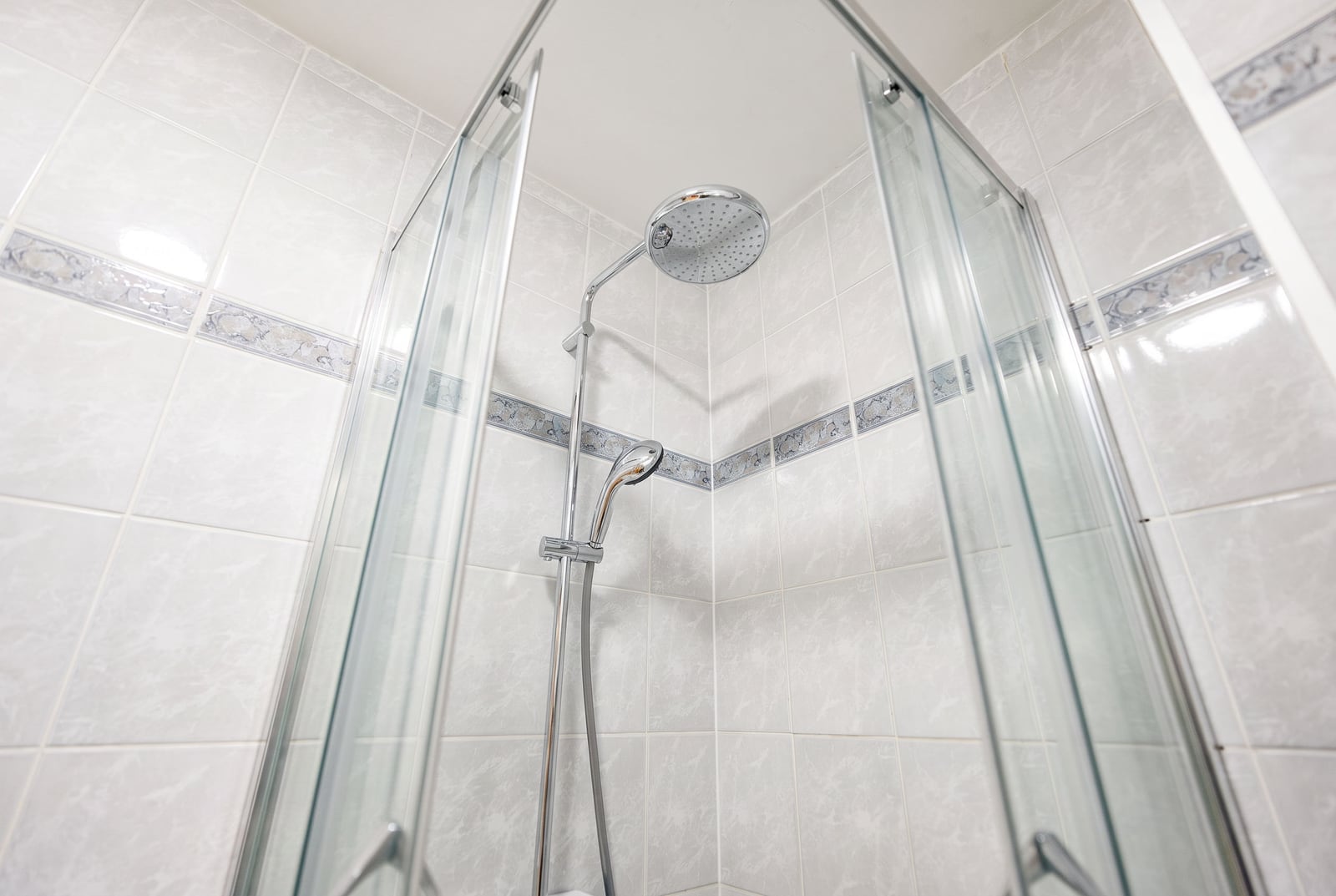 Shower cabin with glass doors and modern sanitary ware in the bathroom of an apartment in Sveti Stefan, Montenegro.