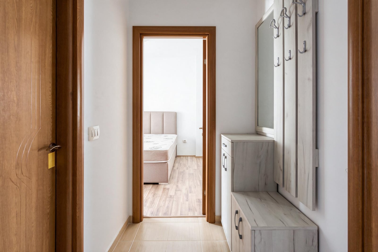 Bright hallway with a coat rack and console table in an apartment in Tivat, Montenegro.