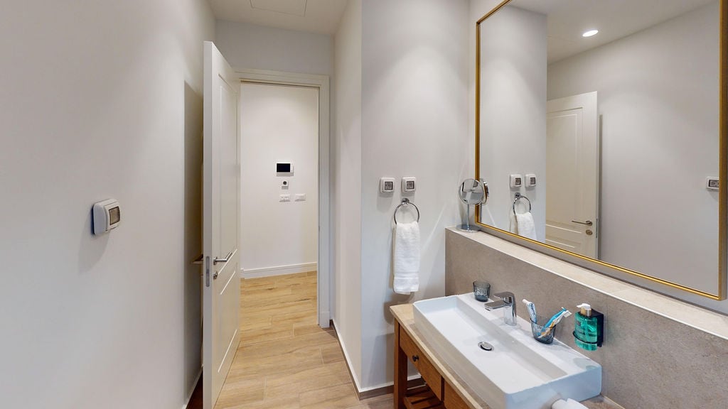 Modern bathroom with a mirror and vanity unit in an apartment at Luštica Bay, Montenegro: stylish interior and finishes.
