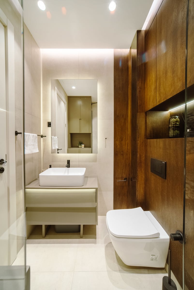 Modern bathroom with wooden finishes and lighting in a luxury apartment, Bečići, Montenegro.