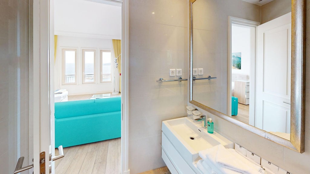 Modern bathroom with a view of the living room and the sea in Luštica apartments, Montenegro.