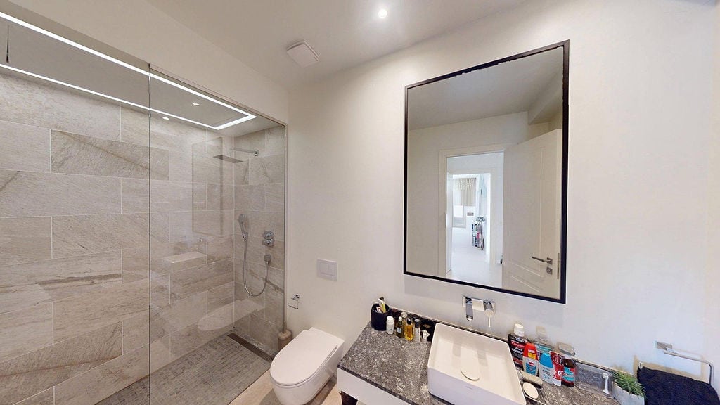Modern bathroom with a shower cabin and stone countertop in an apartment, Luštica, Montenegro.