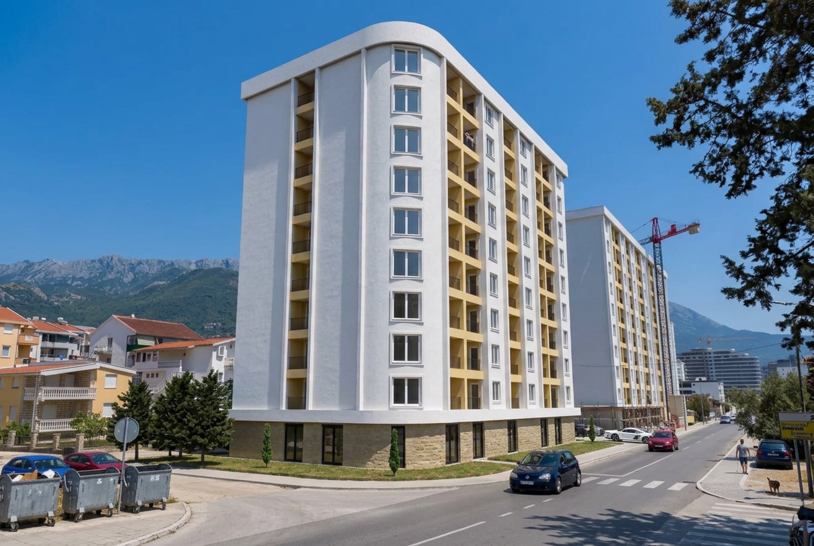 Modern residential complex in Bar, Montenegro: view of a multi-story building with balconies and a mountain landscape.